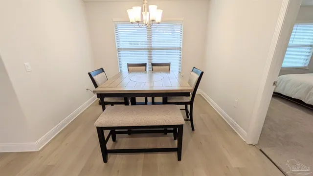a view of a room with furniture and wooden floor