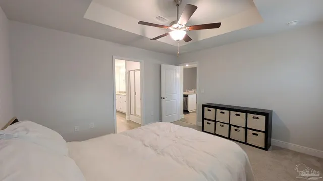 a bedroom with a large bed and a chandelier