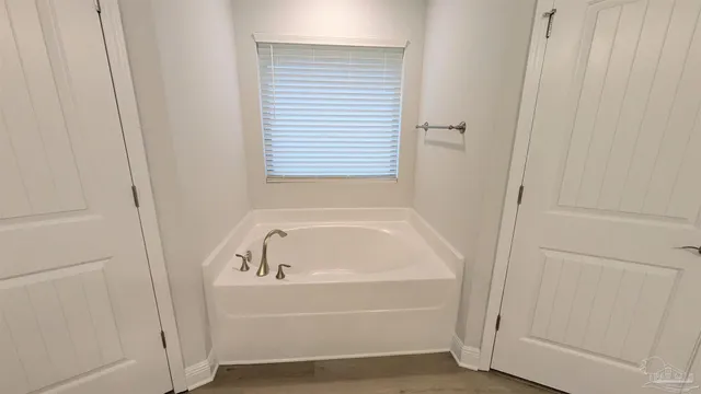a white bath tub sitting next to a window