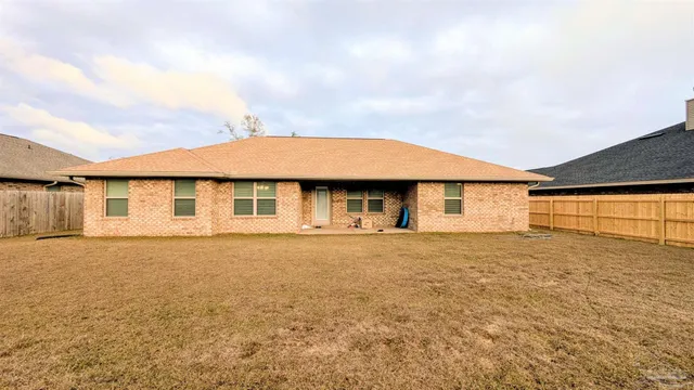 a front view of a house with a garden and garage