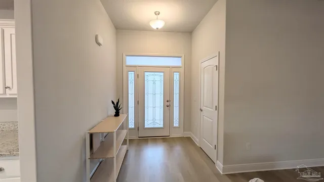 a view of hallway with wooden floor