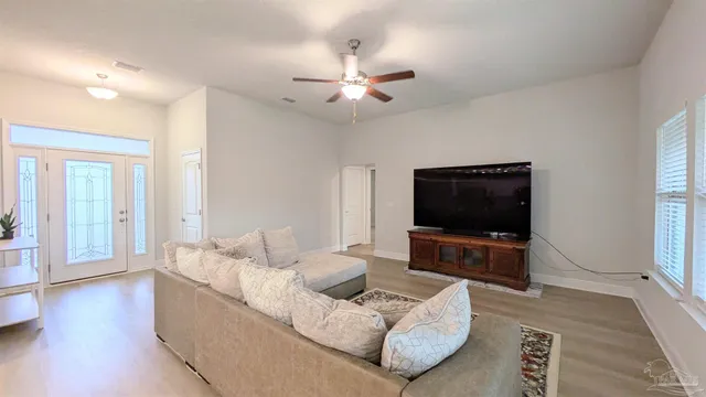 a living room with furniture and a flat screen tv