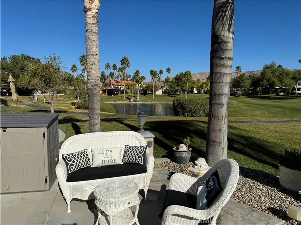a balcony with table and chairs