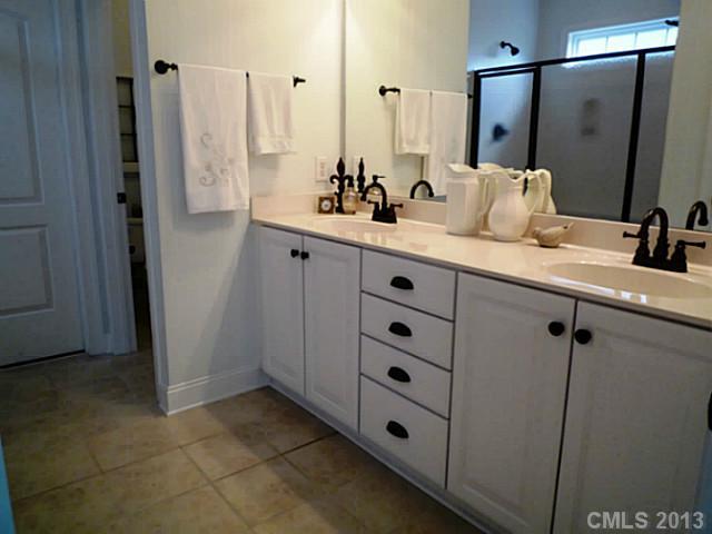 86599 Arrington Road Lancaster, SC 29720 - Photo 9 of 16 a bathroom with a double vanity sink and mirror