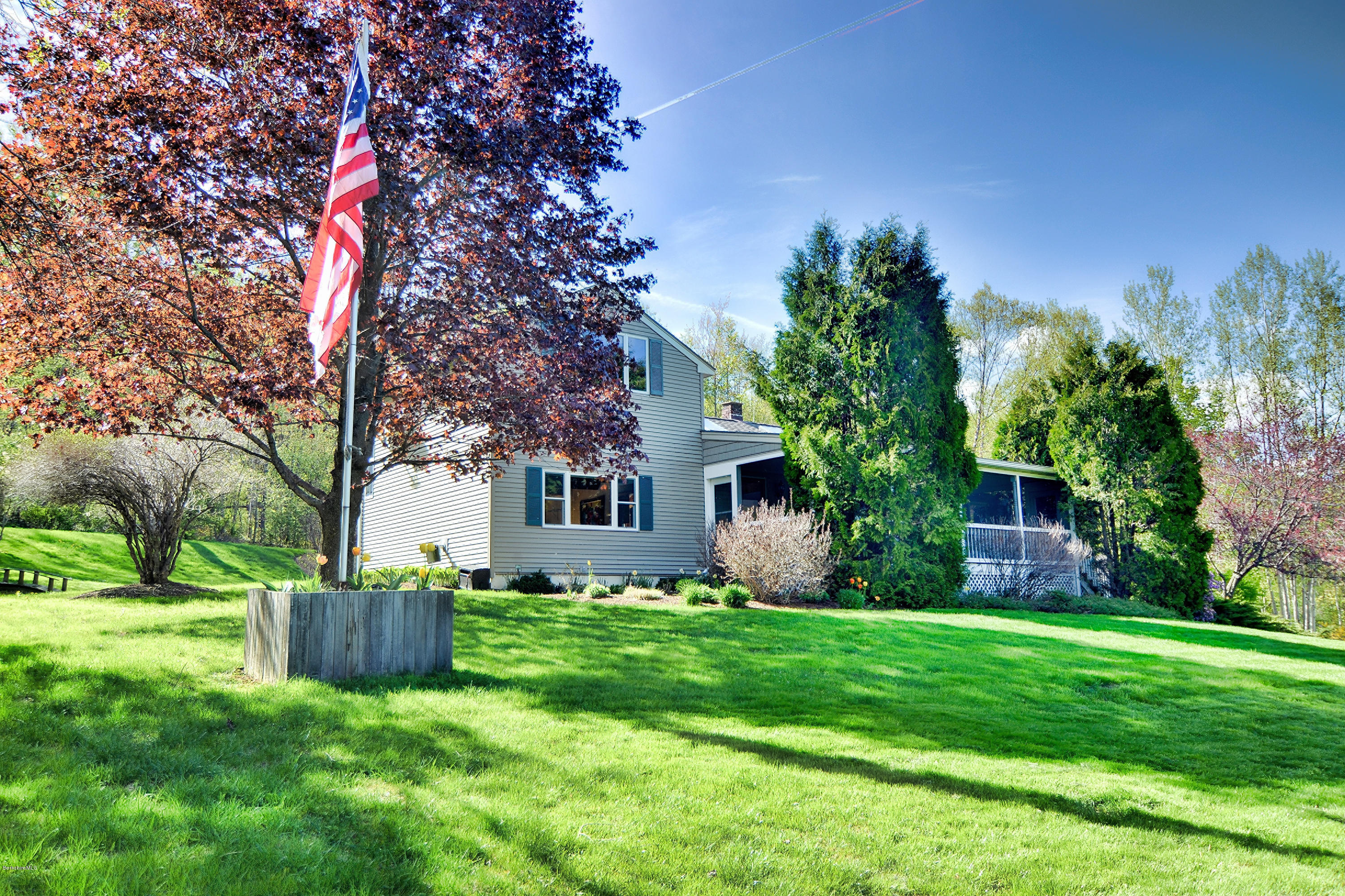 a house view with a sitting space and garden