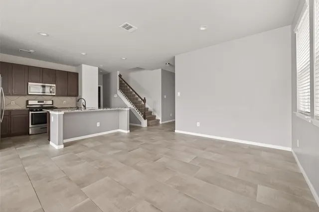 a view of a kitchen with a sink dishwasher and a refrigerator