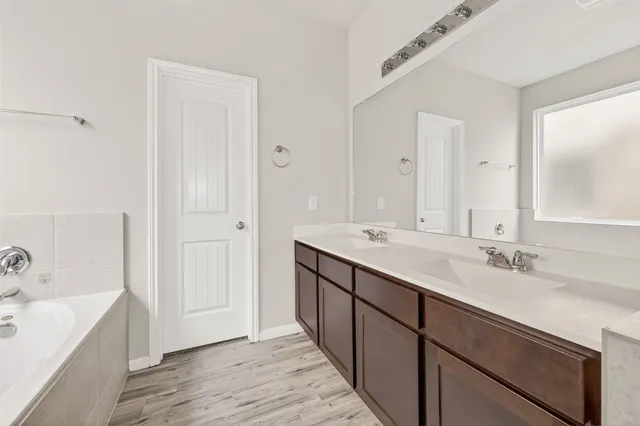 a bathroom with a double vanity sink mirror and double