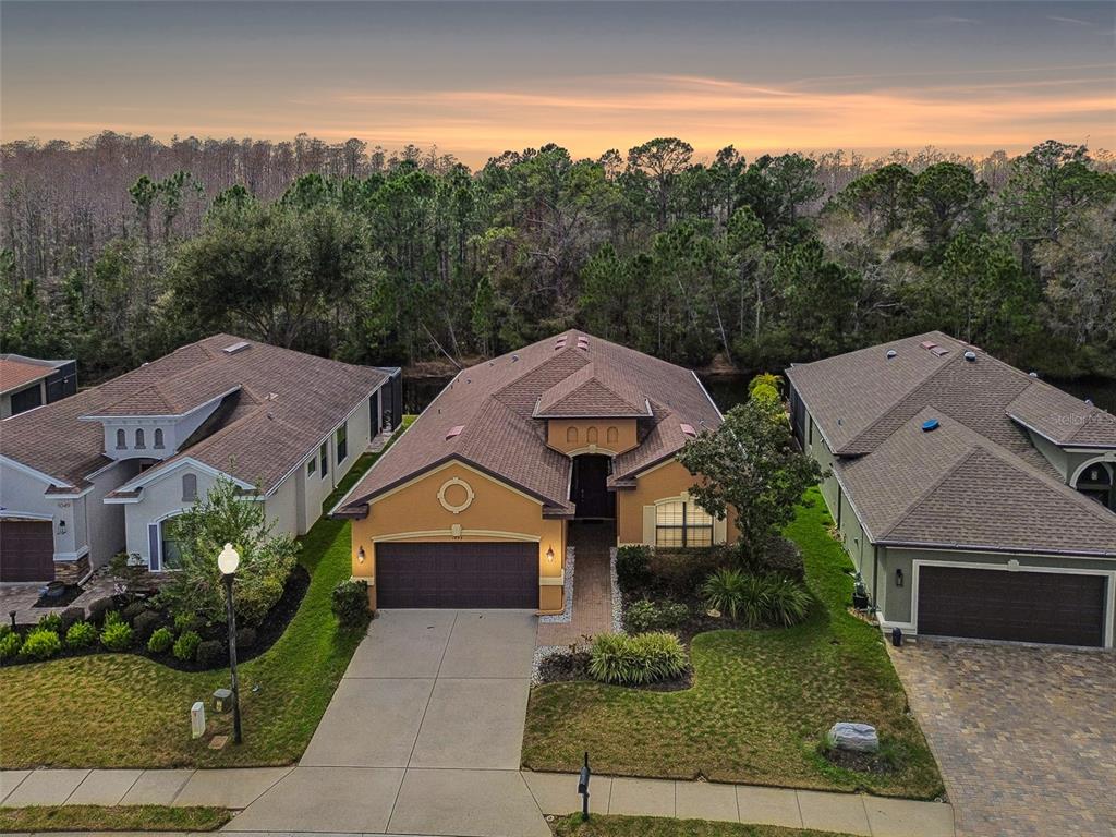 1053 Ketzal Drive Trinity, FL 34655 - Photo 1 of 1 a front view of a house with a yard and garage