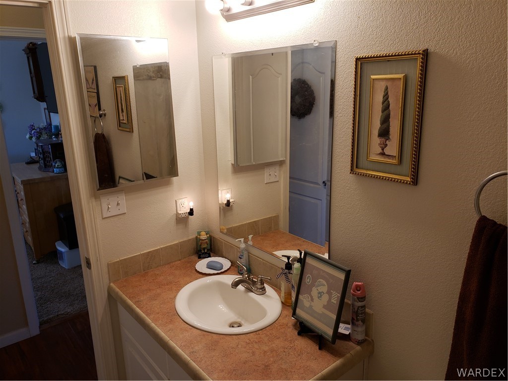 4198 Estrella Road Golden Valley, AZ 86413 - Photo 13 of 50 a bathroom with a sink vanity and mirror