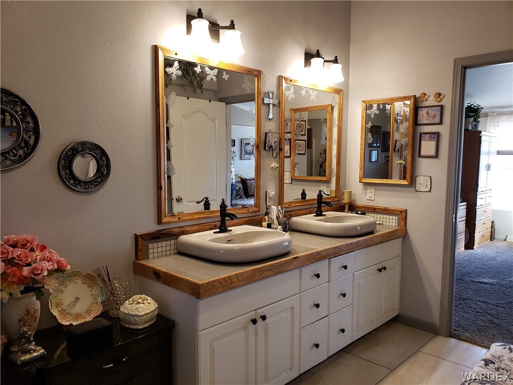 4198 Estrella Road Golden Valley, AZ 86413 - Photo 26 of 50 a bathroom with a double vanity sink and a mirror