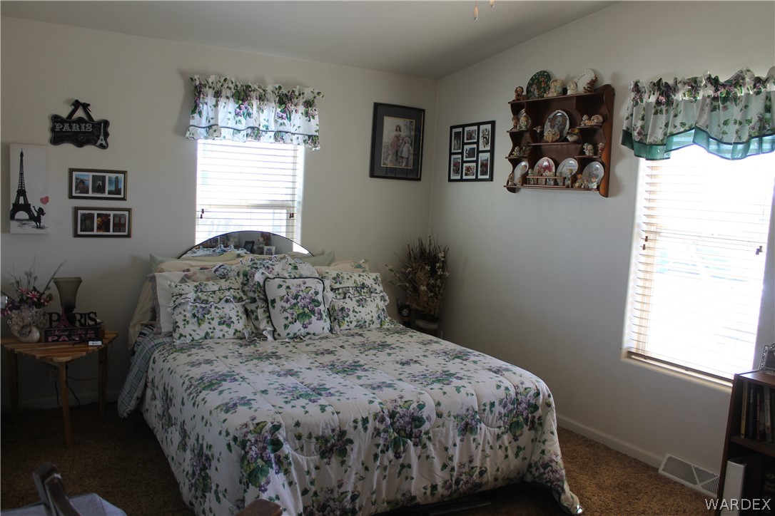 4198 Estrella Road Golden Valley, AZ 86413 - Photo 4 of 50 a bedroom with a bed and a window