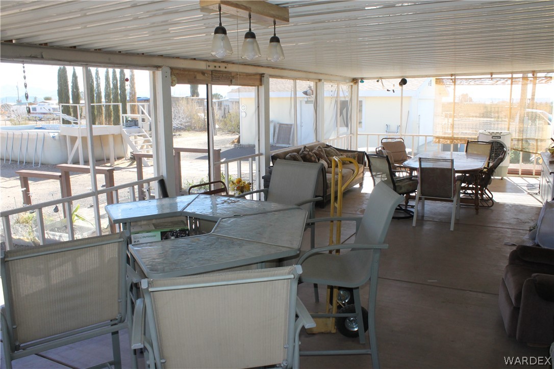 4198 Estrella Road Golden Valley, AZ 86413 - Photo 43 of 50 a dining hall with couches a dining table and chairs with outer view
