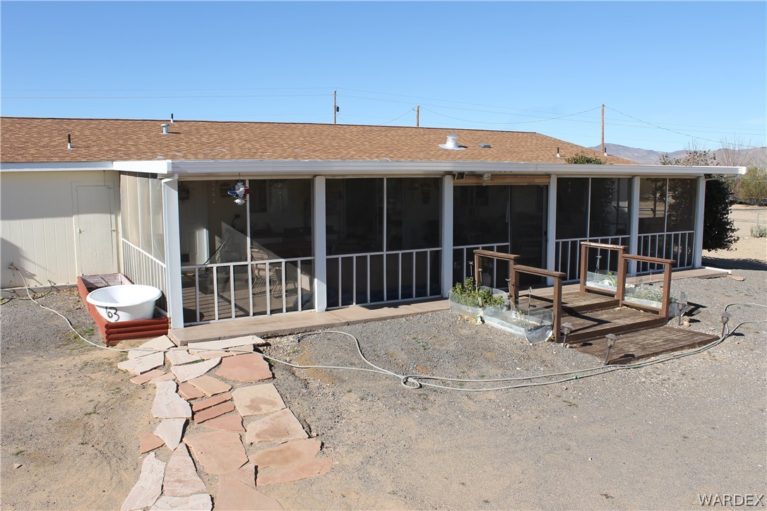 4198 Estrella Road Golden Valley, AZ 86413 - Photo 50 of 50 a view of a patio with a table and chairs and wooden fence
