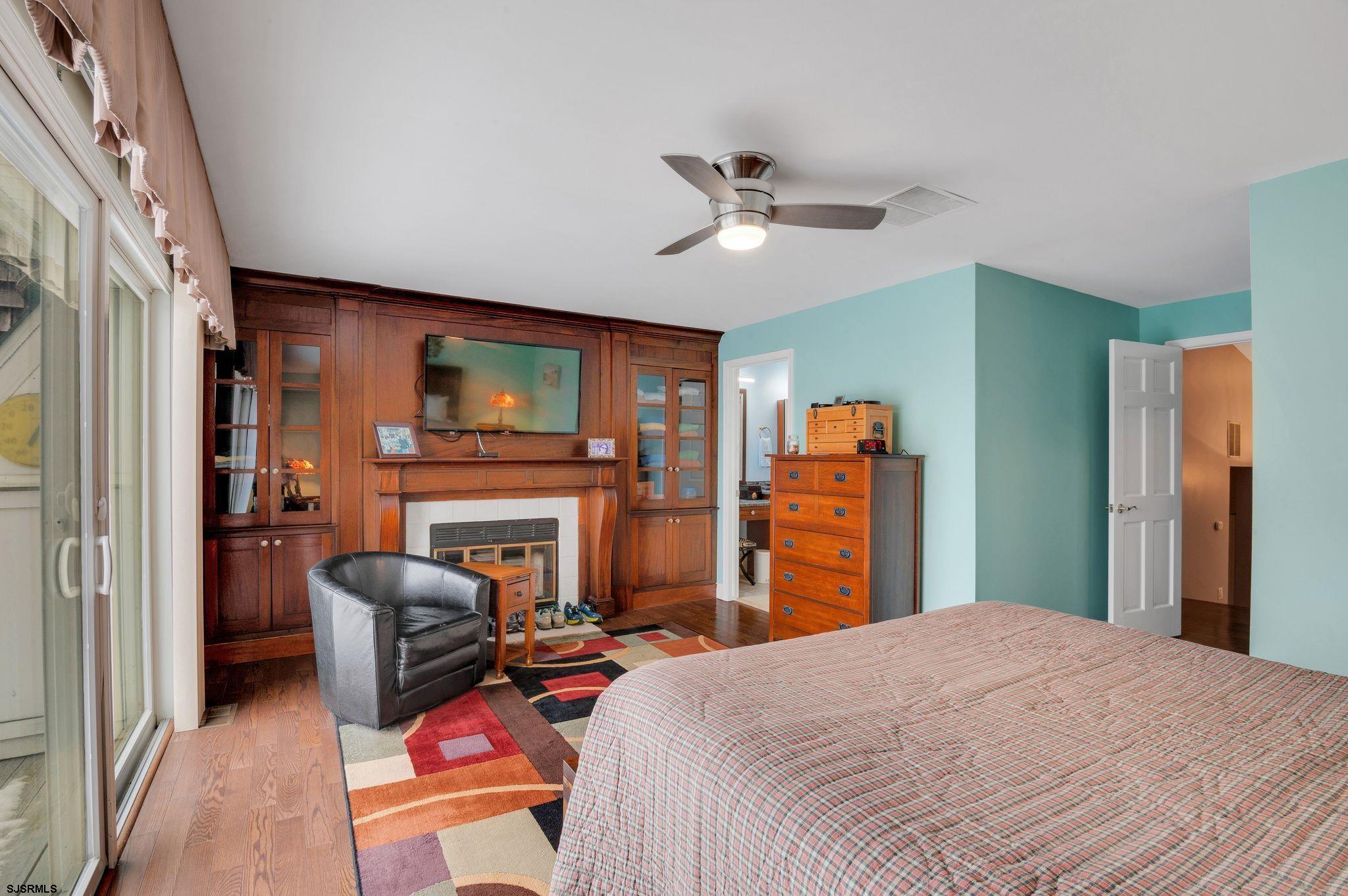 504 Harbour Cove, Unit 504 Somers Point, NJ 08244 - Photo 17 of 30 a bedroom with a bed dresser and a flat tv screen