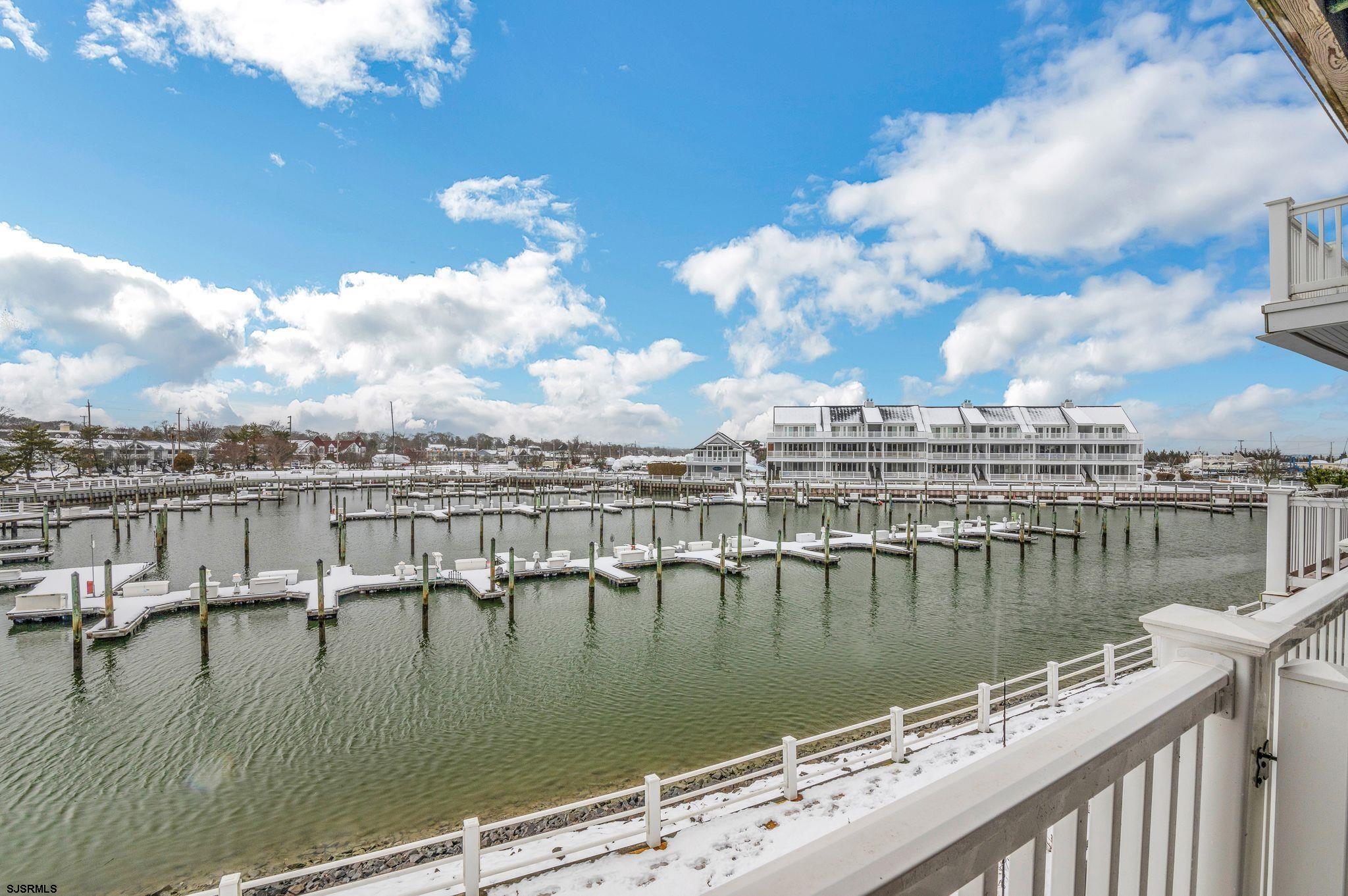 504 Harbour Cove, Unit 504 Somers Point, NJ 08244 - Photo 2 of 30 a view of a lake with boats and trees in the background