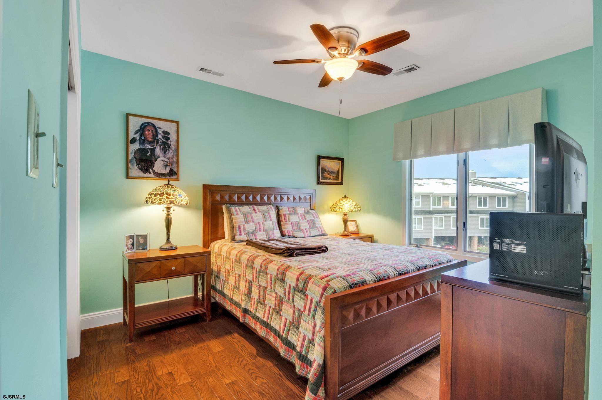 504 Harbour Cove, Unit 504 Somers Point, NJ 08244 - Photo 22 of 30 a bedroom with a bed and a flat screen tv