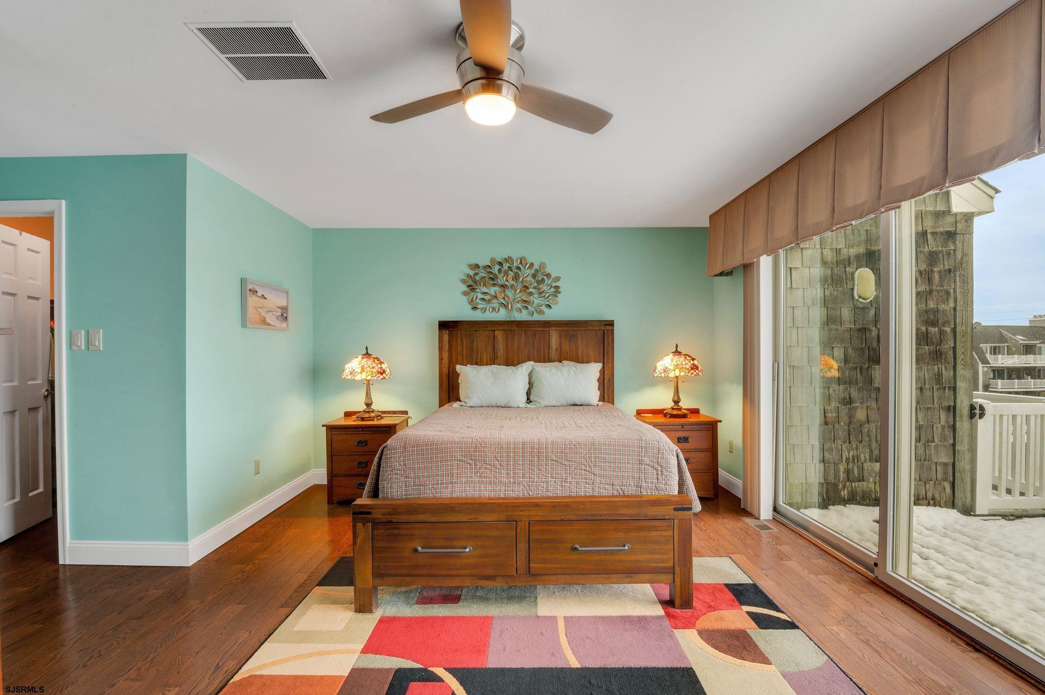 504 Harbour Cove, Unit 504 Somers Point, NJ 08244 - Photo 26 of 30 a bedroom with a bed and a chandelier