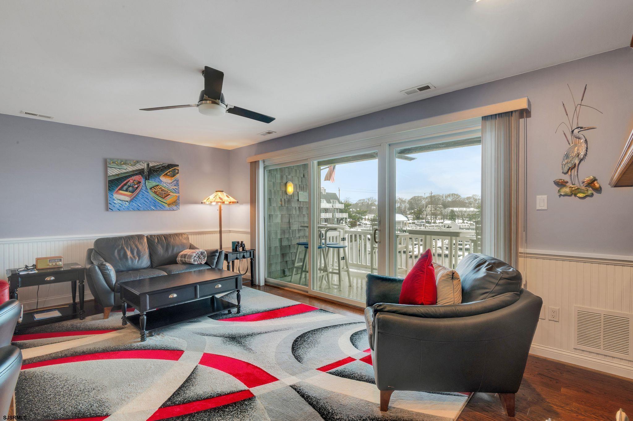 504 Harbour Cove, Unit 504 Somers Point, NJ 08244 - Photo 8 of 30 a living room with furniture and a floor to ceiling window