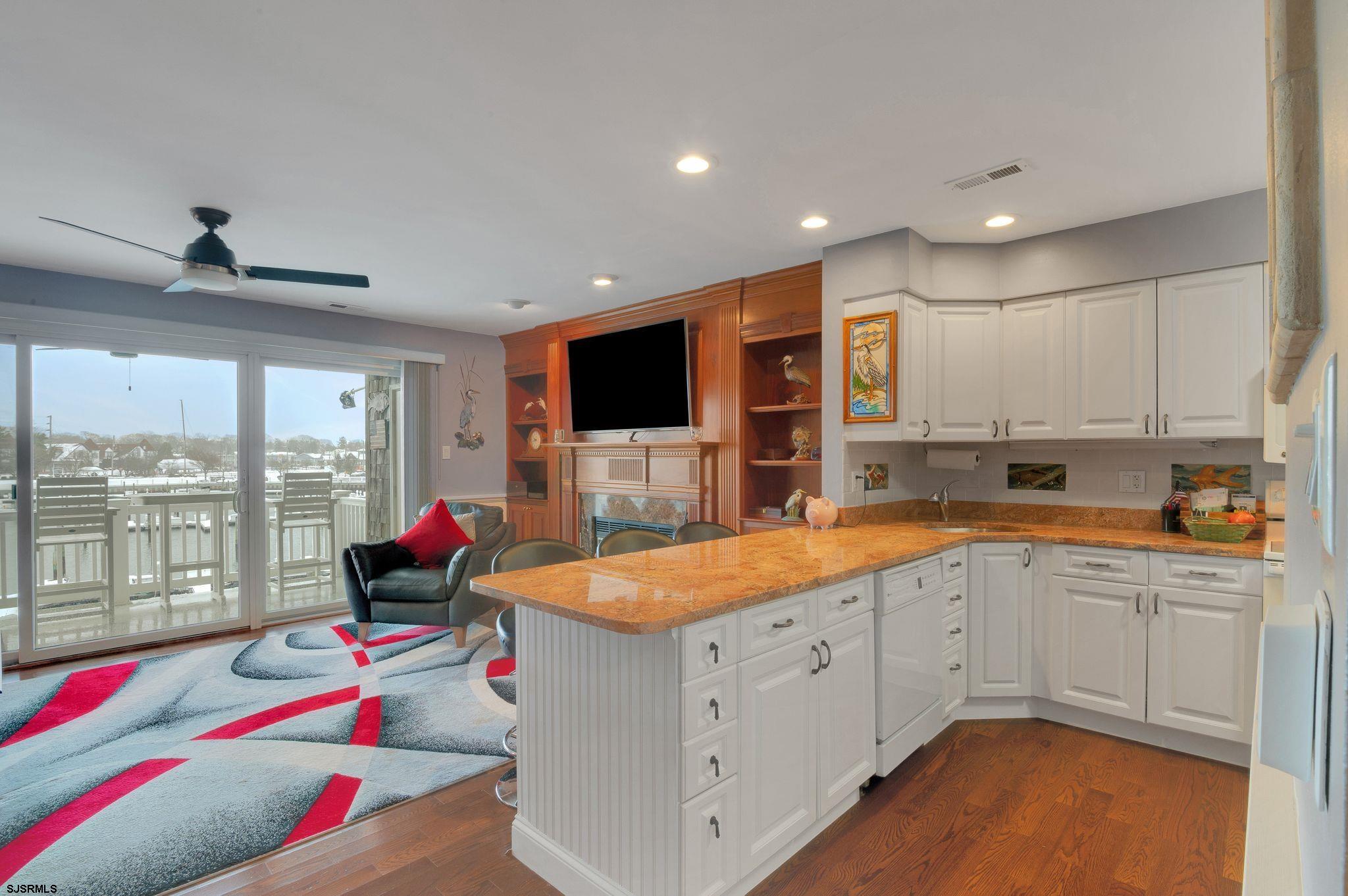 504 Harbour Cove, Unit 504 Somers Point, NJ 08244 - Photo 9 of 30 a very nice looking kitchen with counter top space a sink and living room view