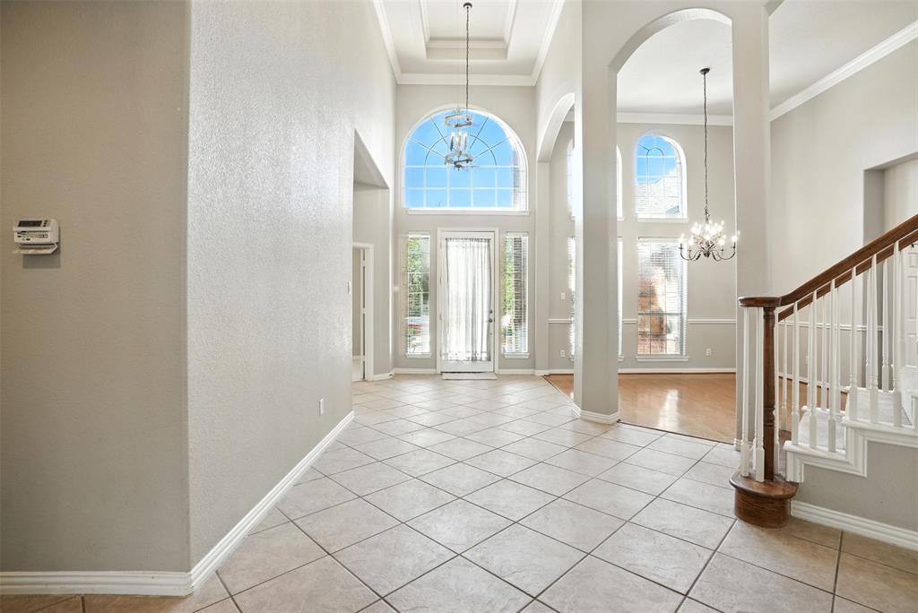8220 Holliday Road Lantana, TX 76226 - Photo 9 of 40 Grand foyer featuring a soaring ceiling, decorative archways, and a tile floor