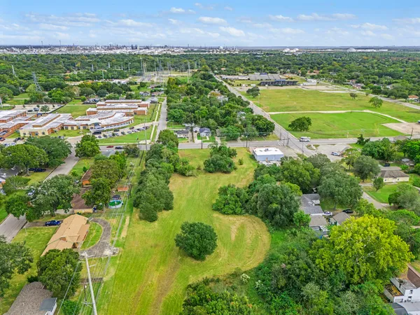 an aerial view of residential houses with outdoor space and river