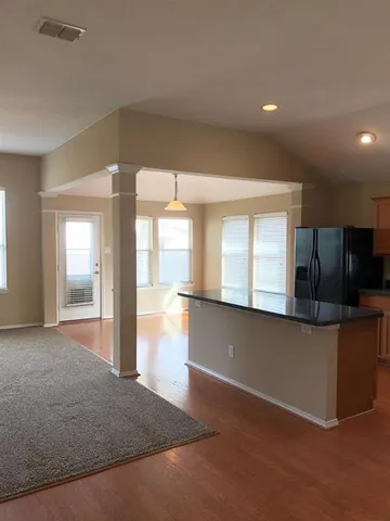 a view of a kitchen with a sink and a large window