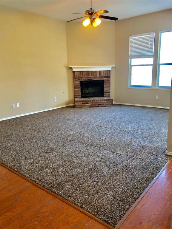 1021 Terrace View Drive Fort Worth, TX 76108 - Photo 7 of 22 an empty room with a fireplace and chandelier