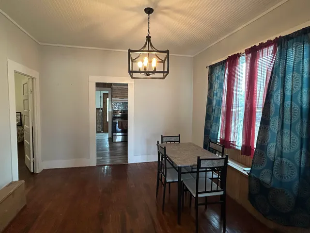 a kitchen with a sink cabinets and wooden floor