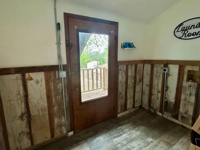 a bedroom with a bed a couch and a chandelier