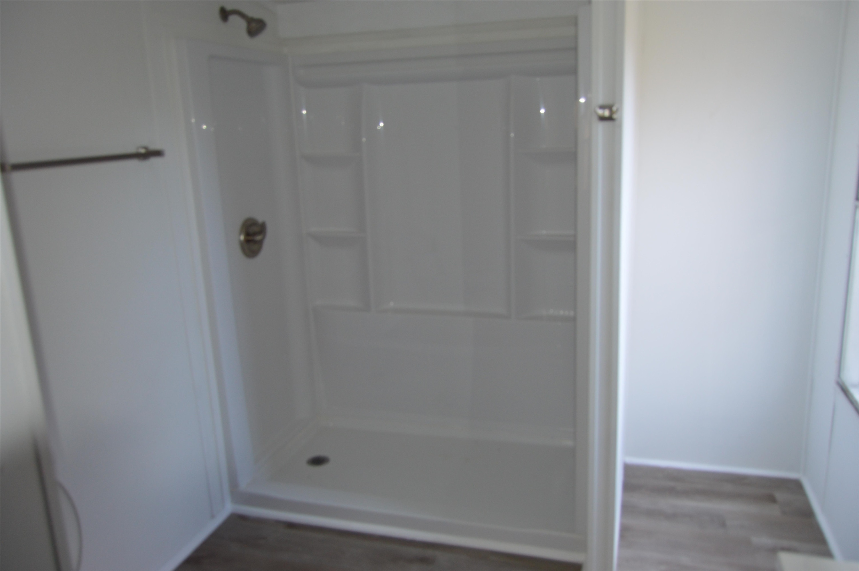879 Holeman Ashley Road Timberlake, NC 27583 - Photo 5 of 9 a bathroom with a glass shower door