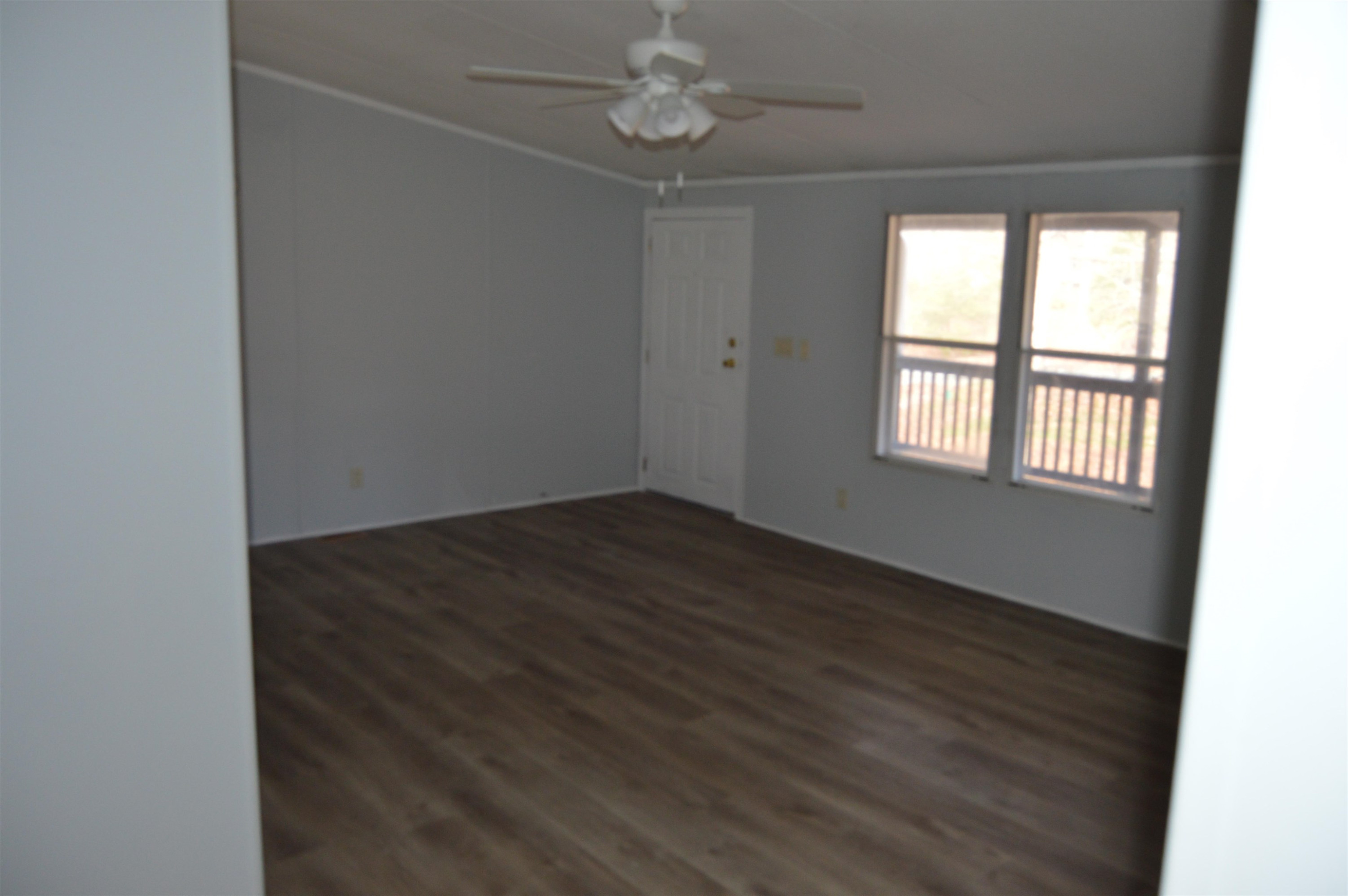 879 Holeman Ashley Road Timberlake, NC 27583 - Photo 7 of 9 an empty room with wooden floor and windows