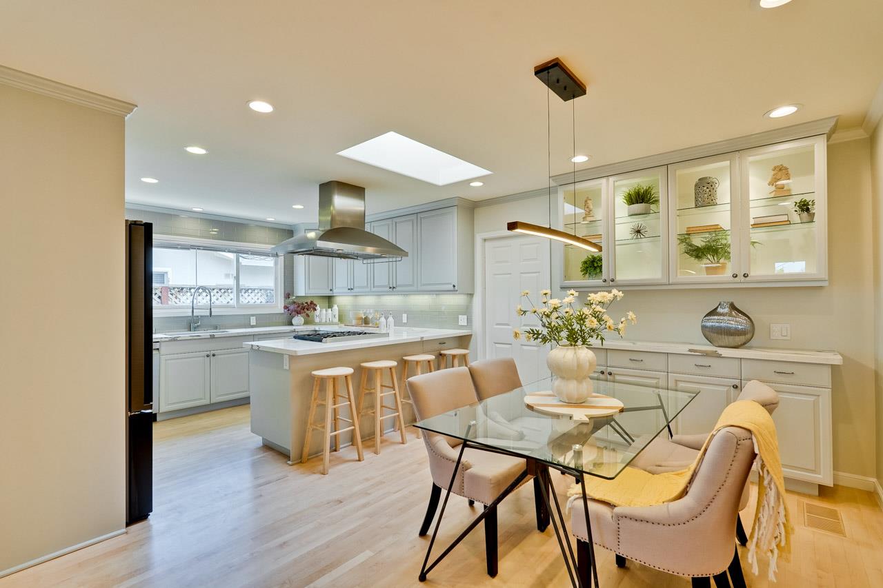 891 Humewick Way Sunnyvale, CA 94087 - Photo 12 of 45 a kitchen with kitchen island a stove a table and chairs in it