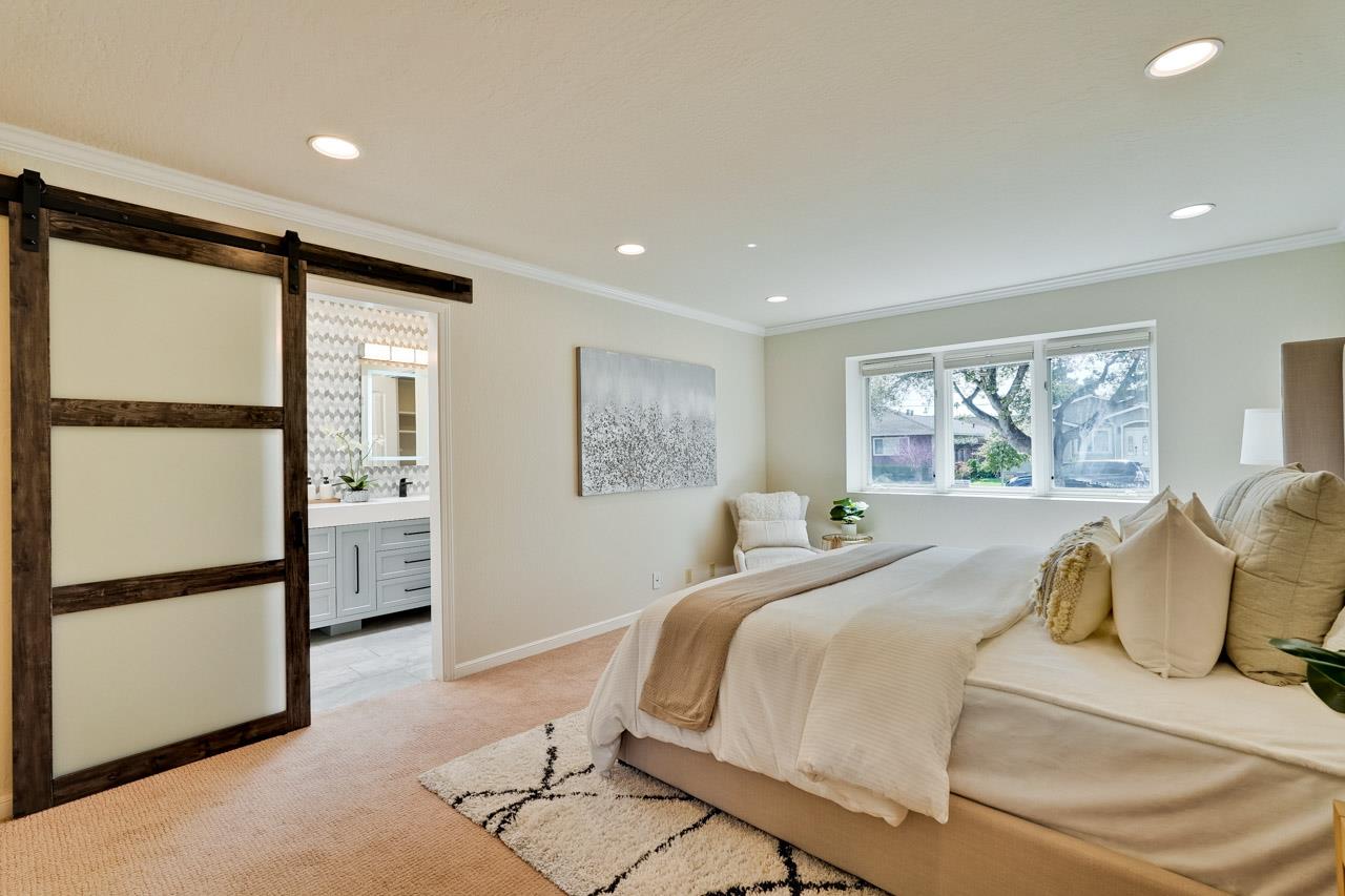 891 Humewick Way Sunnyvale, CA 94087 - Photo 35 of 45 a bedroom with a large bed and a large window