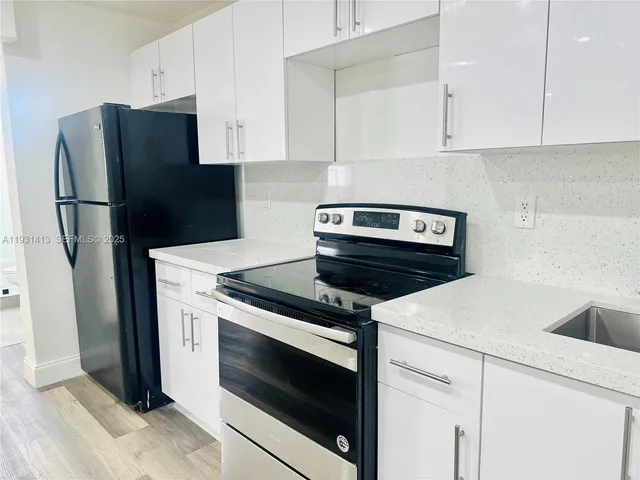 a kitchen with a stove and a refrigerator