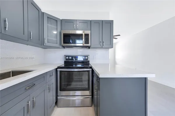 a kitchen with a stove and a microwave