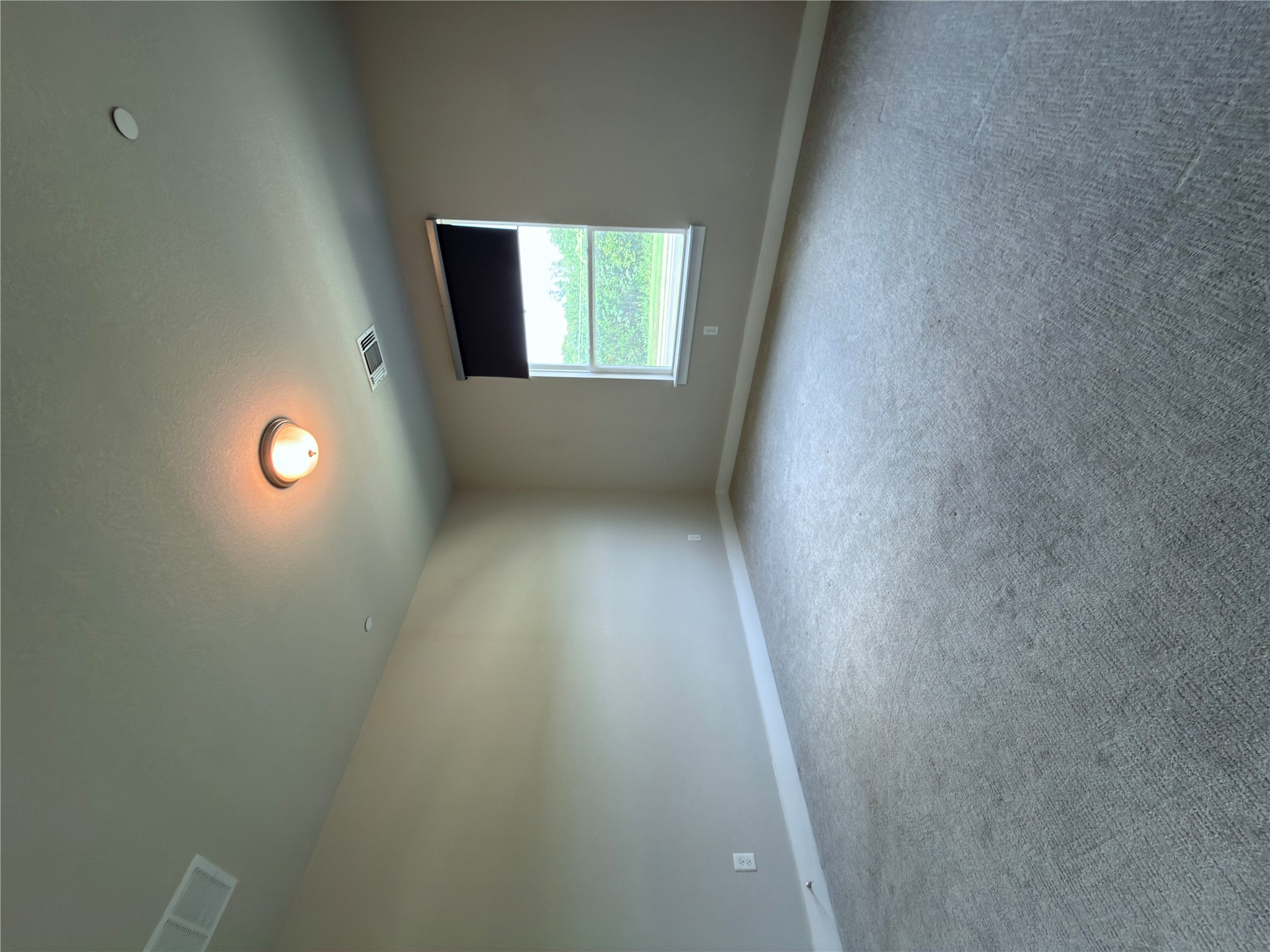 11216 Gadsen Lane Austin, TX 78754 - Photo 22 of 36 An inviting room awaits with soft carpet and natural light filtering through the window.
