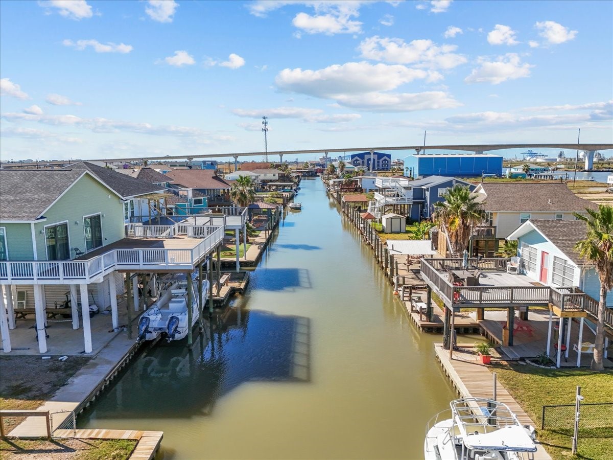 324 Shark Lane Surfside Beach, TX 77541 - Photo 4 of 49 Waterfront homes with private docks line a scenic canal, offering a tranquil, coastal lifestyle. Perfect for boating enthusiasts and those seeking a serene waterside retreat.