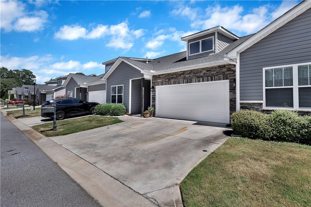 121 Ventura Street Anderson, SC 29621 - Photo 2 of 32 A quiet suburban street with homes featuring modern siding and ample driveway space.