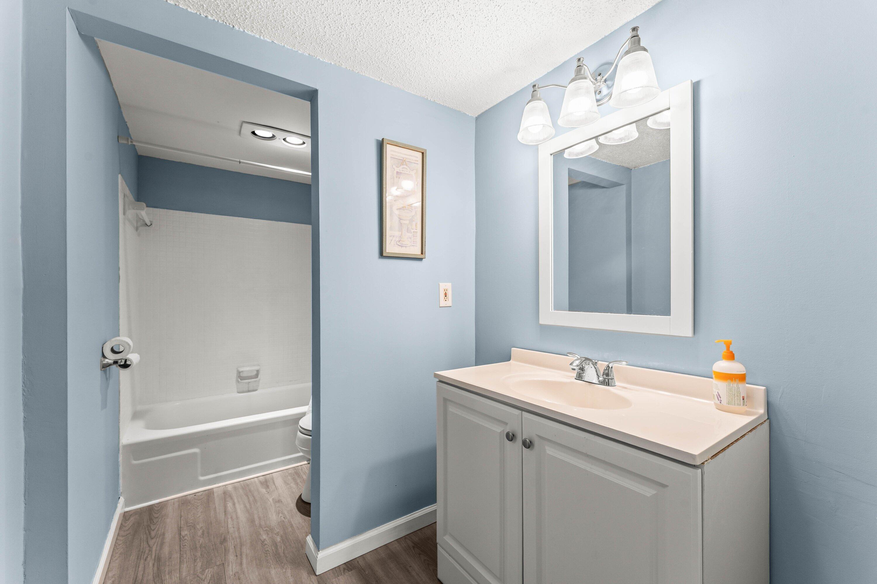 950 South Kanner Highway, Unit C10 Stuart, FL 34994 - Photo 16 of 31 a bathroom with a sink a mirror and a bathtub