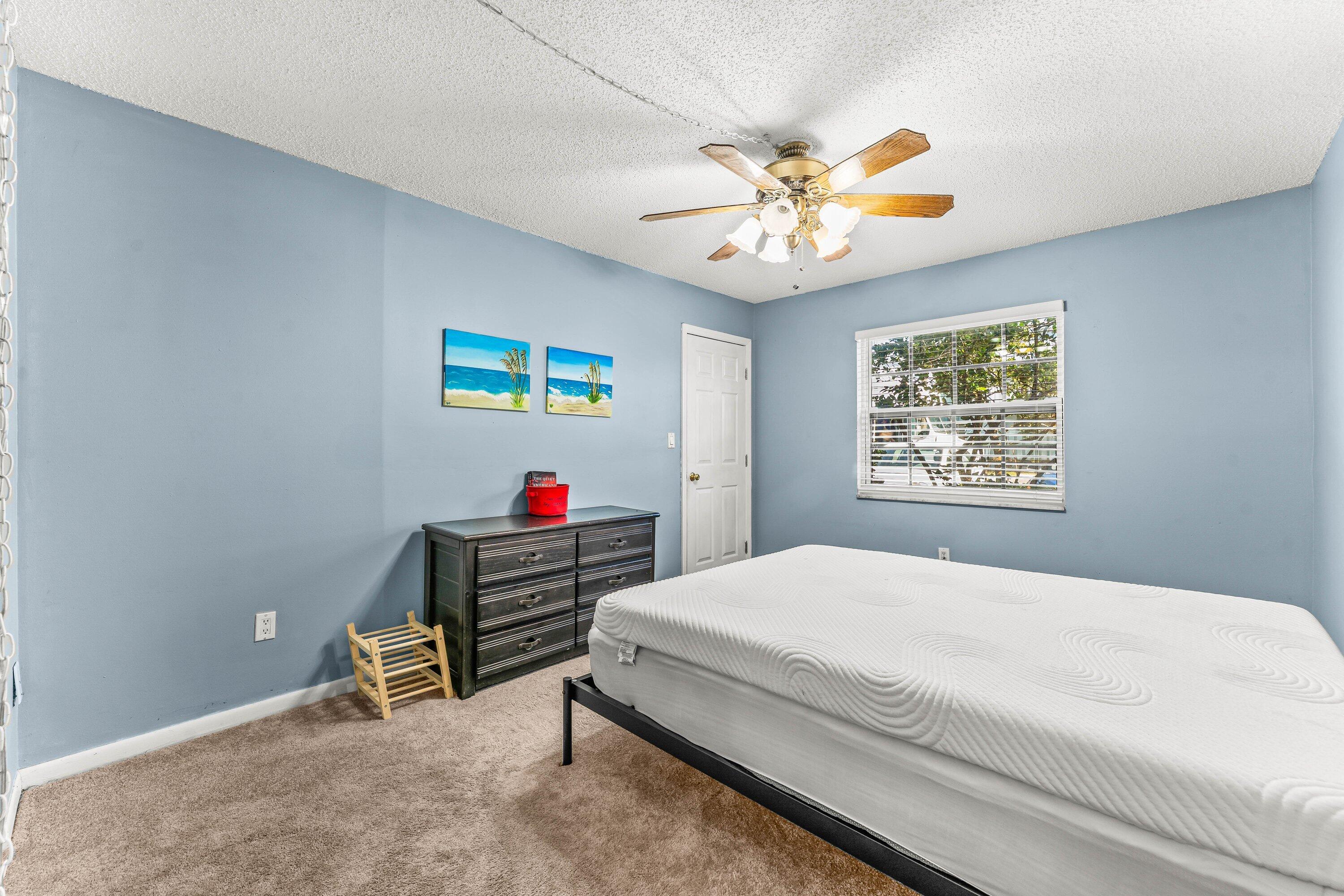 950 South Kanner Highway, Unit C10 Stuart, FL 34994 - Photo 20 of 31 a bedroom with a bed and a chandelier