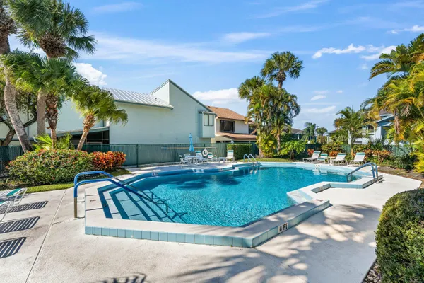 a view of a swimming pool with lounge chairs