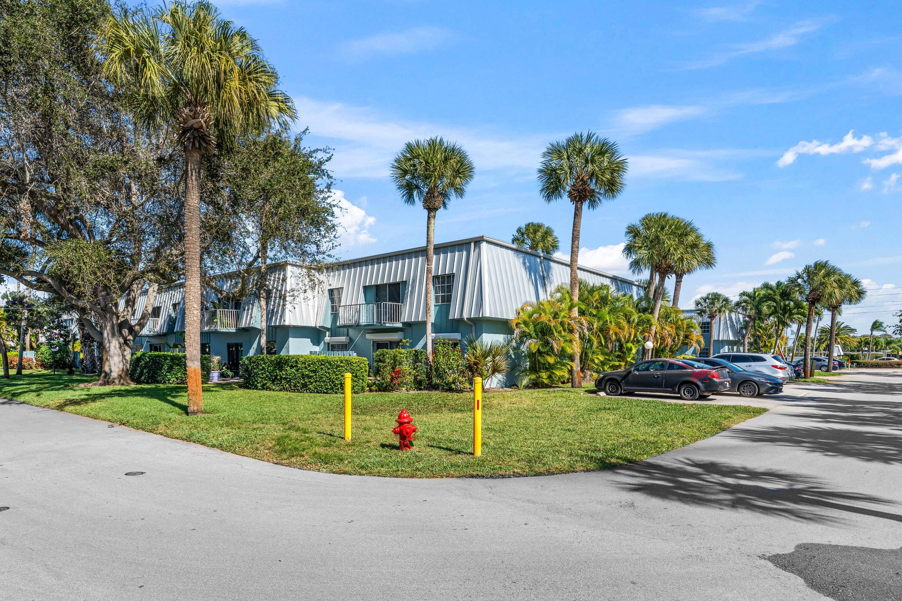 950 South Kanner Highway, Unit C10 Stuart, FL 34994 - Photo 3 of 31 a view of a house with a yard and palm trees