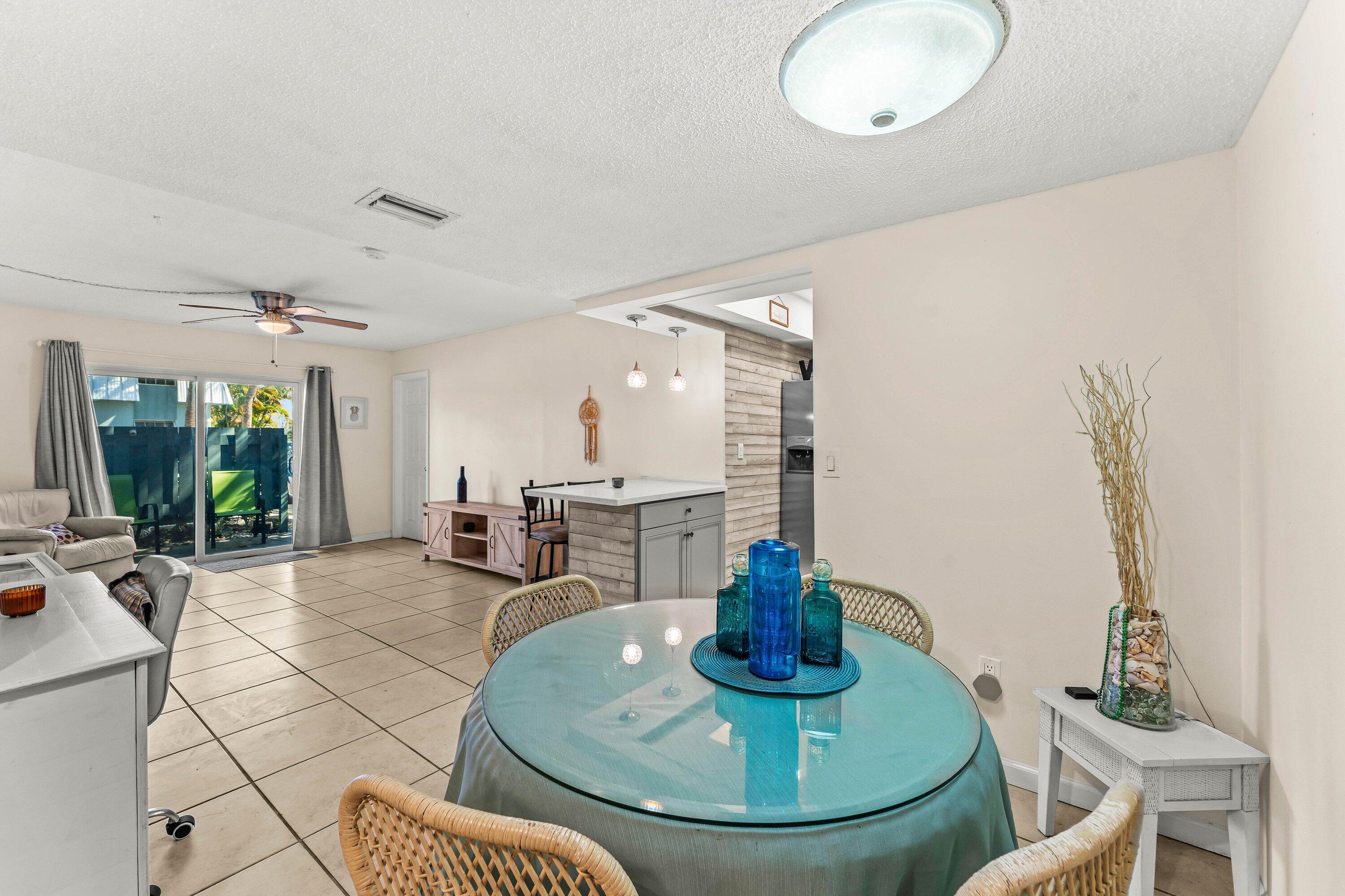 950 South Kanner Highway, Unit C10 Stuart, FL 34994 - Photo 7 of 31 a kitchen with a dining table and chairs