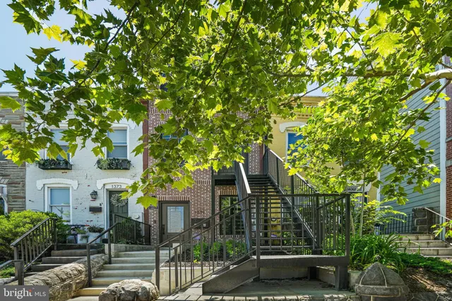 front view of a house with a tree