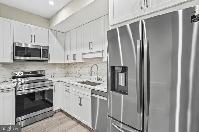 a kitchen with stainless steel appliances a refrigerator stove and microwave