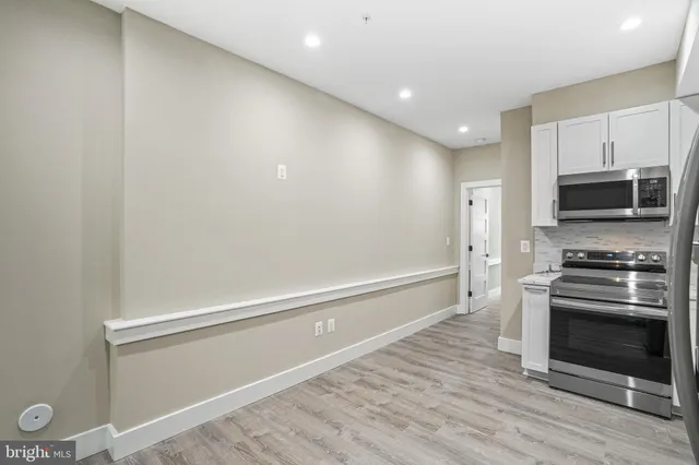 a kitchen with granite countertop a stove and a refrigerator