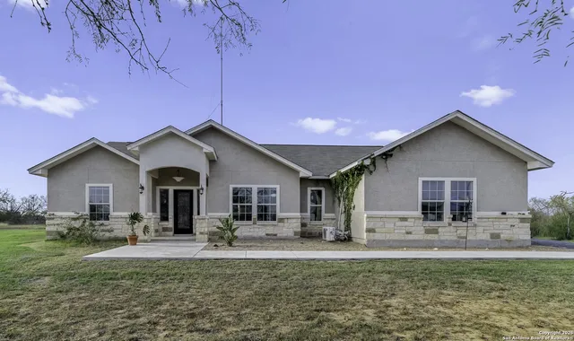 a front view of house with yard and green space