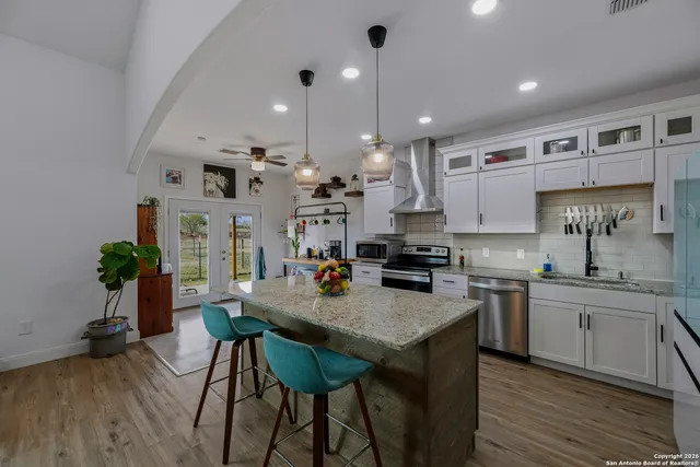a kitchen with a table chairs sink and cabinets
