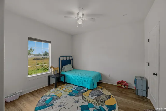 a bedroom with furniture and a window