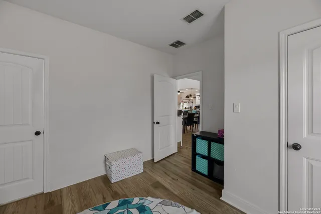 a view of bedroom with furniture and wooden floor